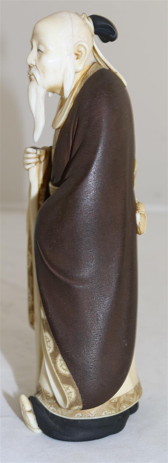 A Japanese ivory figure of a Chinese sage, Taisho period, 18.5cm, loss to staff